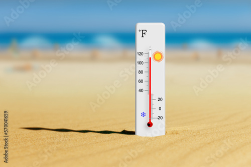 Hot summer day. Fahrenheit scale thermometer in the sand. Ambient temperature plus 112 degrees photo