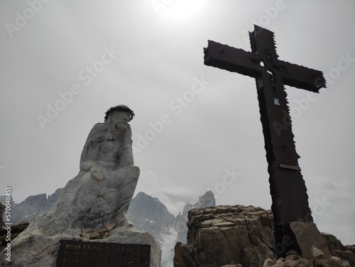 cross with thinking christ on mountain