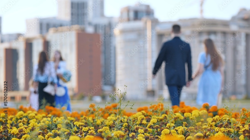 People stroll through the city among the flower beds. People stroll through the city among the flower beds.
