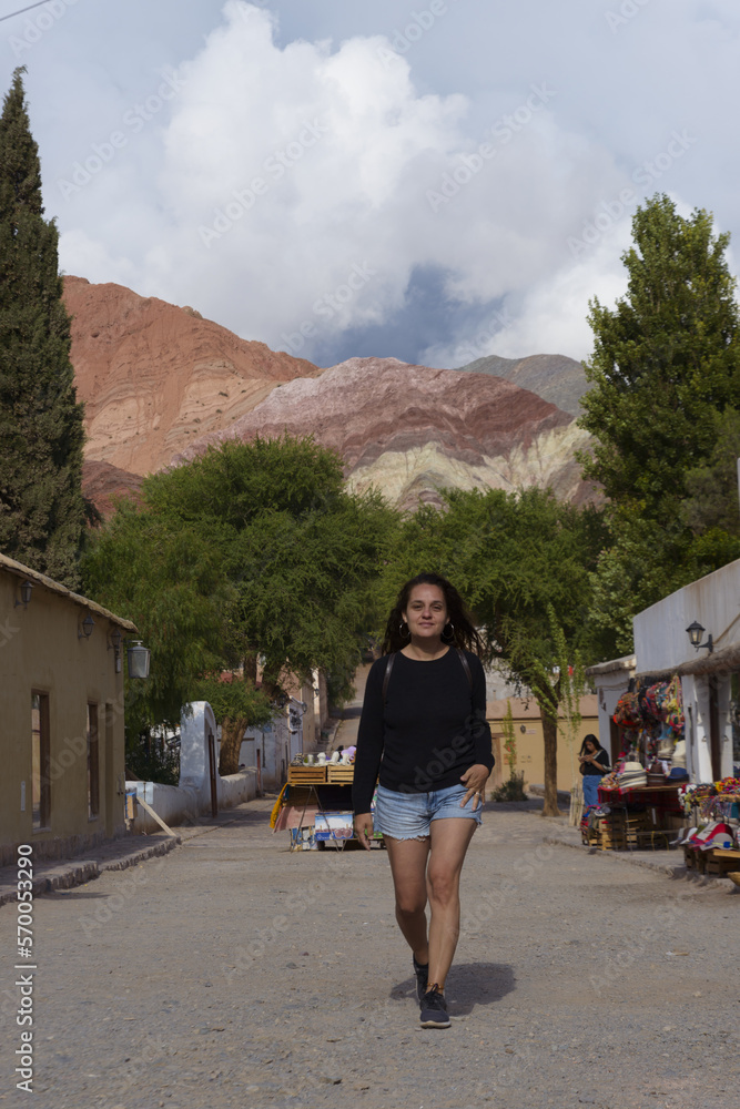 Woman walking in a small town near the mountains