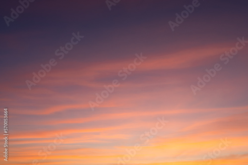Cloudscape of pink clouds and blue sky, golden hour. © LabbePhotography