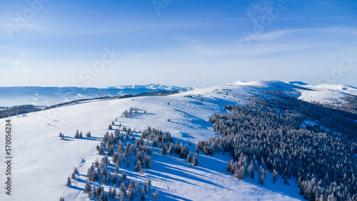 Beautiful mountain range in winter with powder snow and blue sky photo
