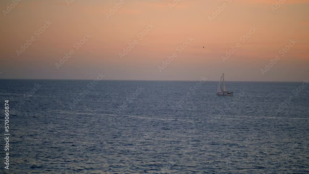 Romantic pink ocean sunset on summer vacation. White yacht sailing calm water Romantic pink ocean sunset on summer vacation. White yacht sailing calm water