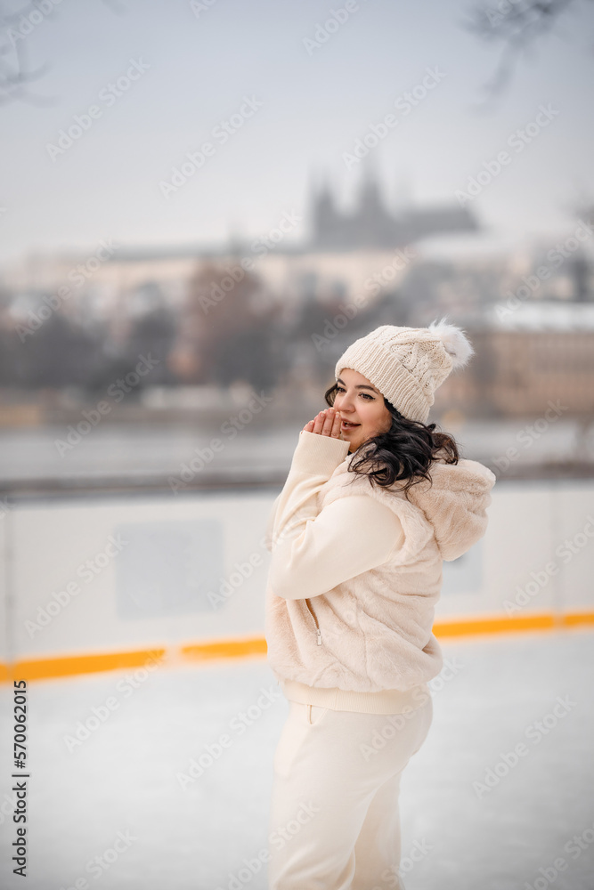 Beautiful girl having fun while skating at ice rink on Prague castle background, Czech republic Beautiful girl having fun while skating at ice rink on Prague castle background, Czech republic