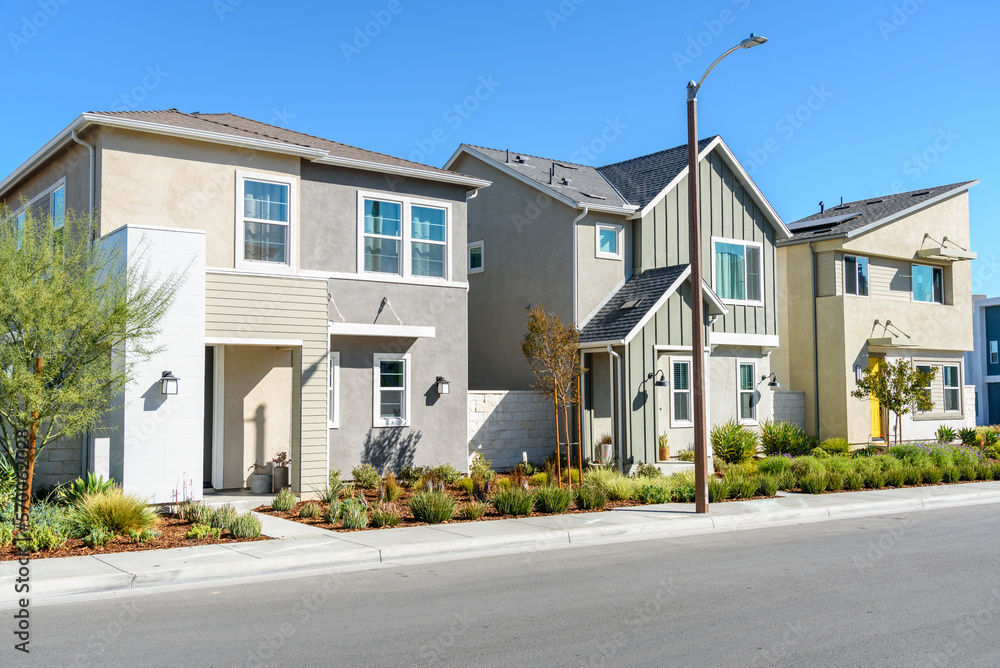 Modern detached houses in a housing development in on a clear autumn day Modern detached houses in a housing development in on a clear autumn day