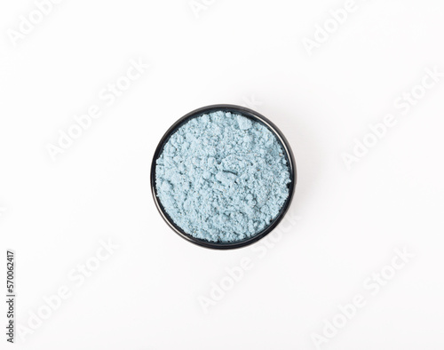 Blue spirulina powder in bowls isolated on white background. Natural vegan superfood. Food supplement. Phycocyanin extract.