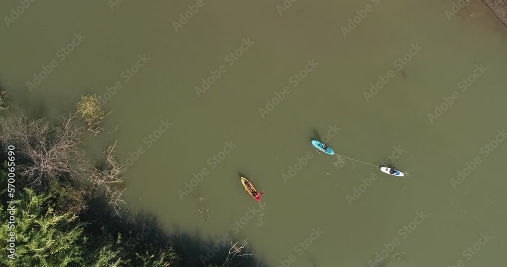Sea of Galilee, Israel - 4 November 2022: Aerial view of people kayaking in a lake. Sea of Galilee, Israel - 4 November 2022: Aerial view of people kayaking in a lake.