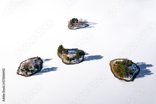 Islands on a snow-covered lake. Islands on a frozen lake.  © Grzegorz