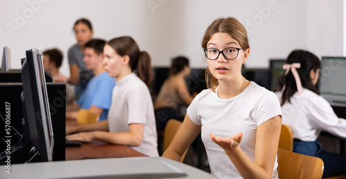 Friendly schoolgirl invites to the computer class of the school