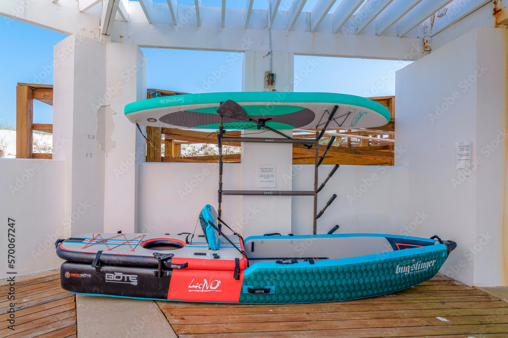 DESTIN, FLORIDA CIRCA MAY, 2022 Kayak and paddle board inside a building. Kayaking vessel on