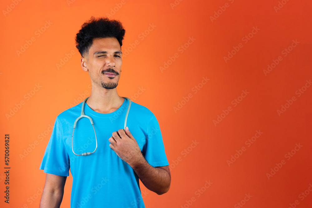 Doctor or Veterinarian Isolated. Black Young Doctor Medical Resident With Stethoscope on Orange Background.