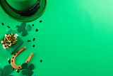 Image of green hat, clover and copy space on green background