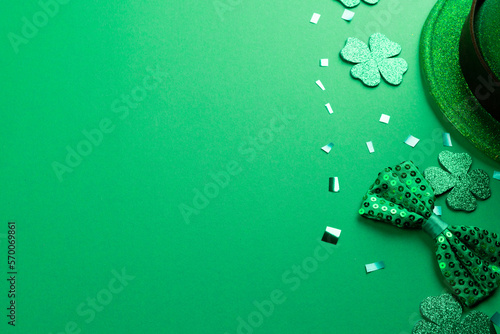 Image of green hat, clover and copy space on green background