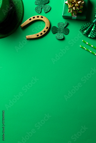 Image of green hat, clover, horse shoe and copy space on green background