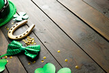 Image of green hat, green clover, horse shoe and copy space on wooden background