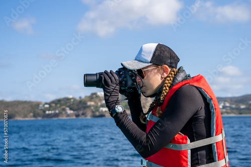 Marine biologist taking photos on the sea