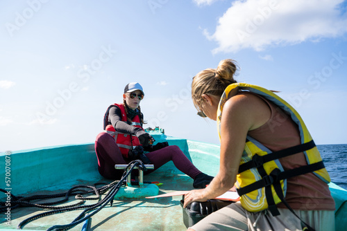 Two marine biologist working on a boat on the sea © carles