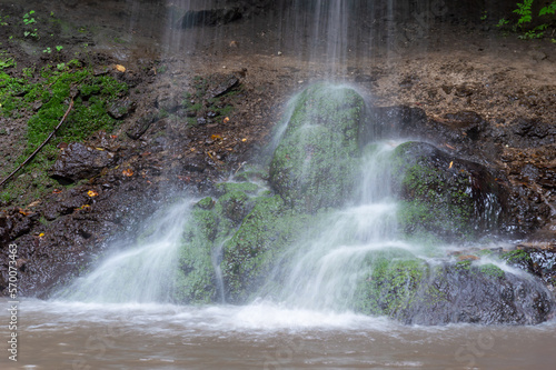 Beautiful fall of the waterfall on the stones