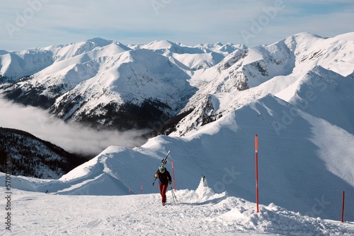 Beautiful winter scenery of Kasprowy Wierch Peak in Tatras Mountains, famous place in Tatras with cable railway. Poland. Tatra National Park. Silhouette of skier on trail. 