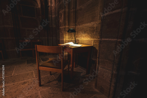 Open book, lamp in the ancient Gothic cathedral