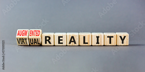 Augmented or virtual reality symbol. Concept words Augmented reality Virtual reality on wooden cubes. Beautiful grey table grey background. Business augmented or virtual reality concept. Copy space.