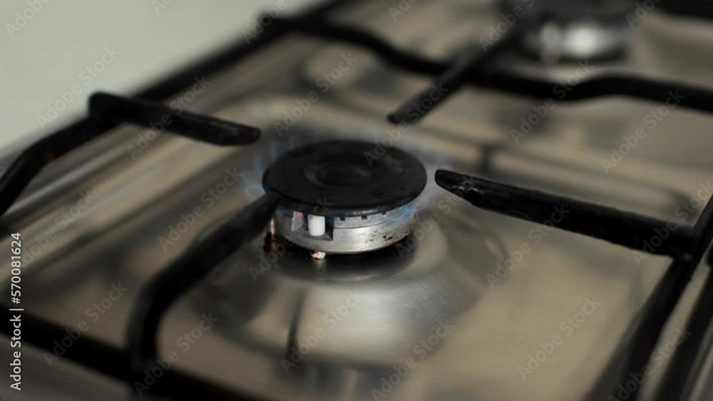 Kitchen gas stove burner inflame. slow motion igniting gas flame. Blue