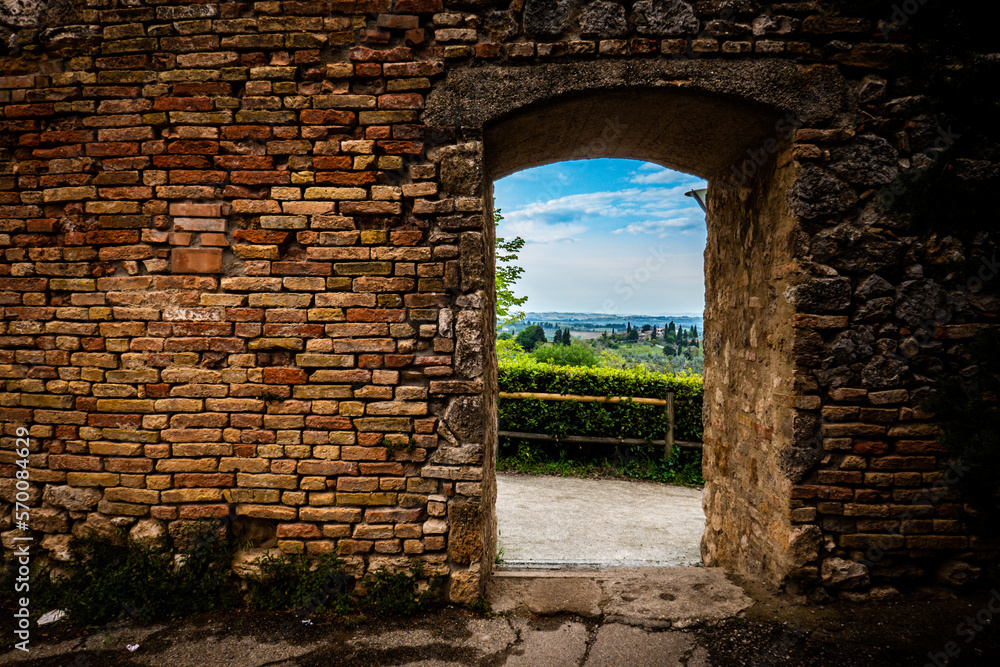 view of tuscany through city walls in italy view of tuscany through city walls in italy