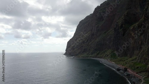 Beautiful aerial or drone shot along the coast of Madeira Island in Portugal. Epic cliffs and ocean waves. Untouched, powerful nature. Flying forward.