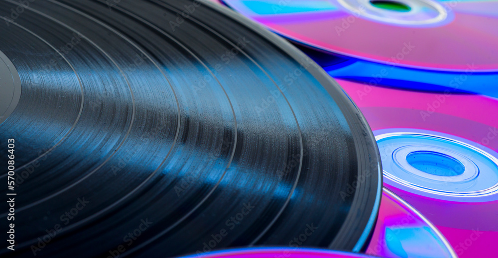 beautiful background with a vinyl record and CDs. music entertainment technology concept beautiful background with a vinyl record and CDs. music entertainment technology concept