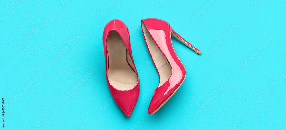 Stylish pink high heeled shoes on color background Stylish pink high heeled shoes on color background