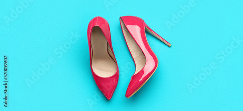 Quadro em tela Stylish pink high heeled shoes on color background