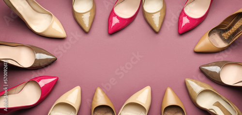 Frame made of different stylish high heeled shoes on pink background. Banner for design