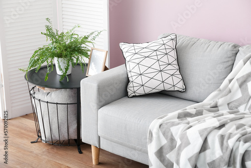 Interior of stylish living room with grey sofa and table