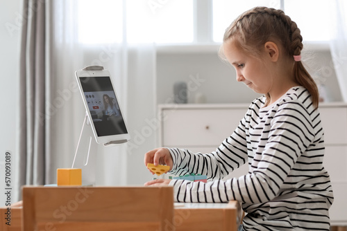 Upset little girl with cube...