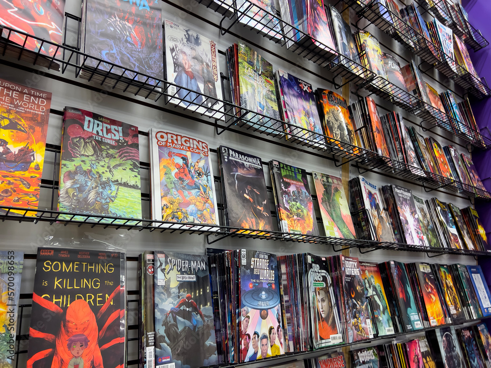 Fototapeta premium Lynnwood, WA USA - circa January 2023: Close up view of popular comics for sale inside a Phantom Zone Comics store.