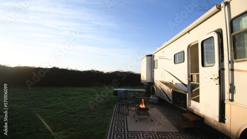 Early morning campsite with campfire