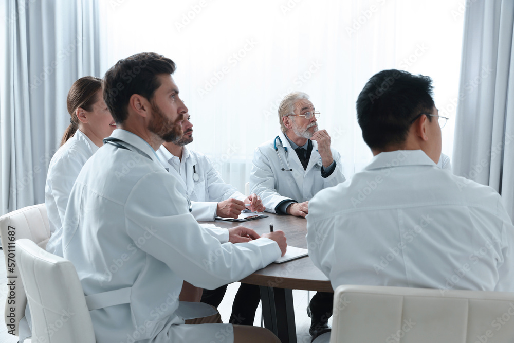 Team of doctors watching presentation in room. Medical conference Team of doctors watching presentation in room. Medical conference