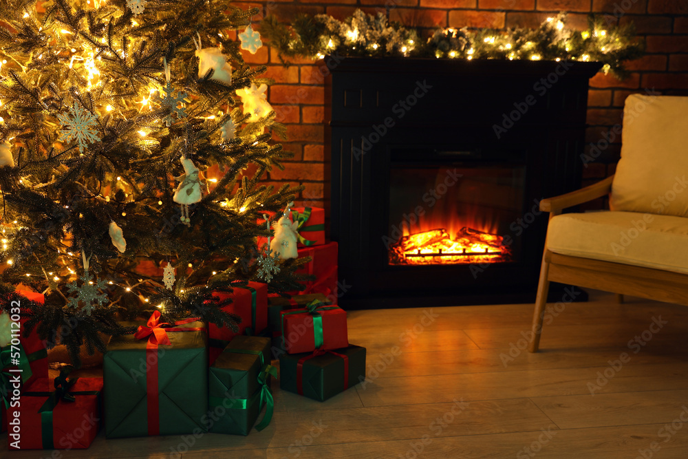 Beautifully wrapped gift boxes under Christmas tree in living room Beautifully wrapped gift boxes under Christmas tree in living room