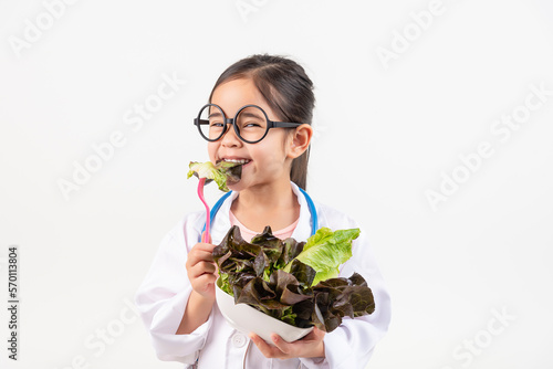 Asia little girl playing doctor recommends vegetables and fruits for proper nutrition and benefits to your health isolated on white