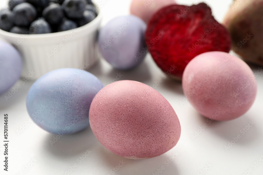 Colorful Easter eggs painted with natural dyes on white table, closeup Colorful Easter eggs painted with natural dyes on white table, closeup