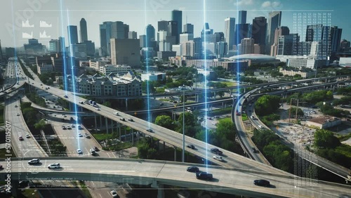 Autonomous cars on highway with traffic in Houston, Texas. Aerial reverse dolly with animation motion graphic of code, graphs, and tracking of self driving cars. Futuristic driving and city theme.
