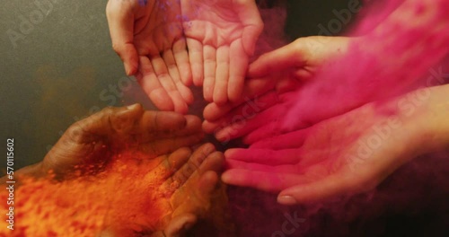 Video of multi coloured powders over hands with copy space