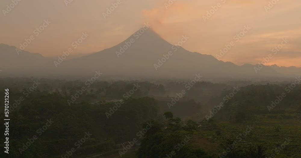 Aerial Beautiful View Of Mountain Under Clouds, Drone Flying Forward Over Forest Landscape During Sunset - Java, Indonesia Aerial Beautiful View Of Mountain Under Clouds, Drone Flying Forward Over Forest Landscape During Sunset - Java, Indonesia