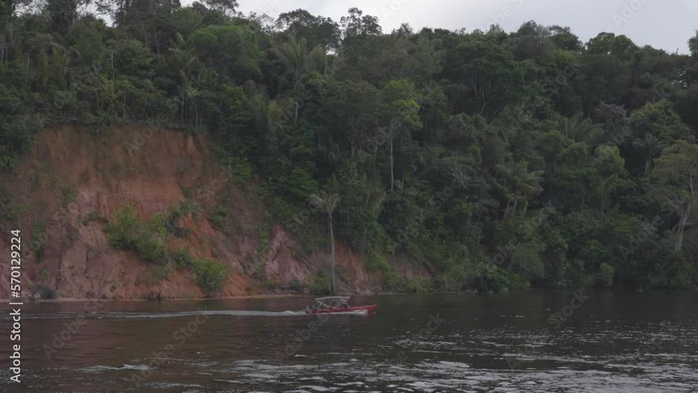 People Riding Motorboat In Sea By Forest During Vacation - Manaus, Brazil People Riding Motorboat In Sea By Forest During Vacation - Manaus, Brazil