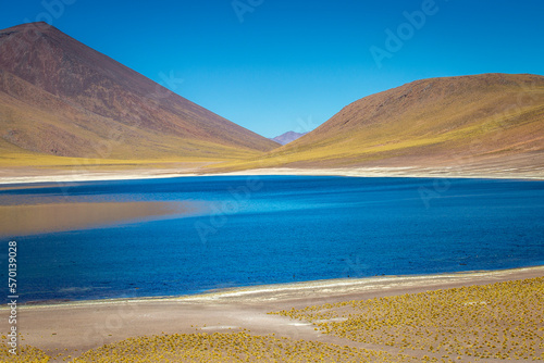 Salt lake, turquoise Laguna Miniques, volcanic landscape at sunrise, Atacama