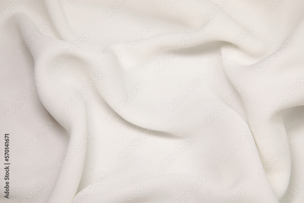 White fabric background. White cloth waves background texture. White fabric cloth textile material.