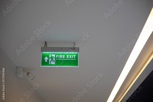 Green signs indicating fire exits installed in the building. except copy space