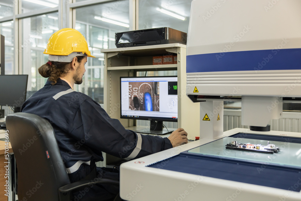 Engineer Working with Digital Microscope for Printed Circuit Board Quality Control Inspector Process.Printed Circuit Board Designer Engineer Working with Digital Microscope for Printed Circuit Board Quality Control Inspector Process.Printed Circuit Board Designer