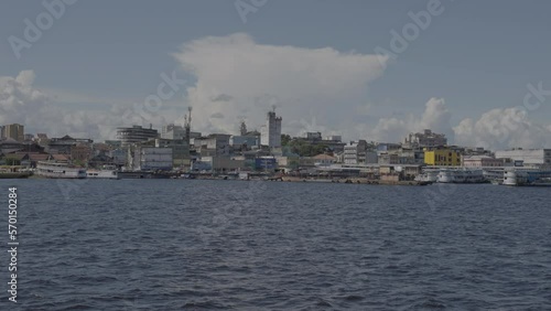 Wallpaper Mural Point Of View Slow Motion Panning Shot Of Residential City Against Cloudy Sky Seen From Wavy Sea On Sunny Day - Manaus, Brazil Torontodigital.ca