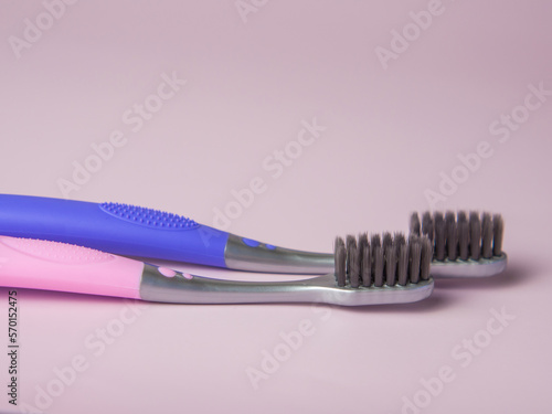 black toothbrush on pastel background closeup